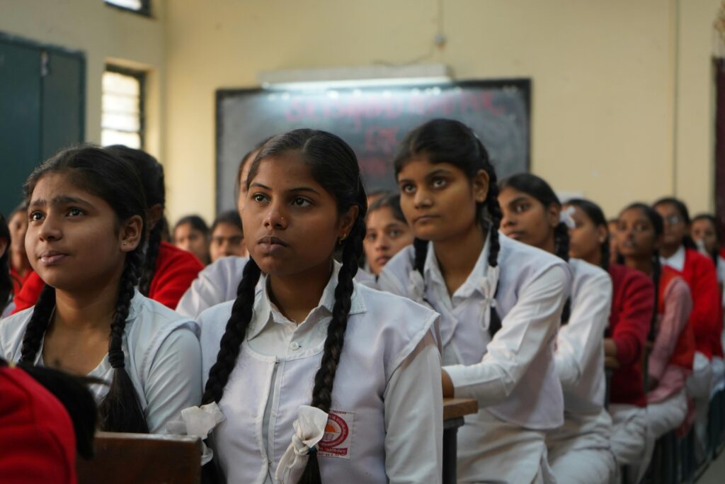 pexels photo 3231358 3231358 Group of Indian schoolgirls attentively listening in their classroom wearing uniforms.